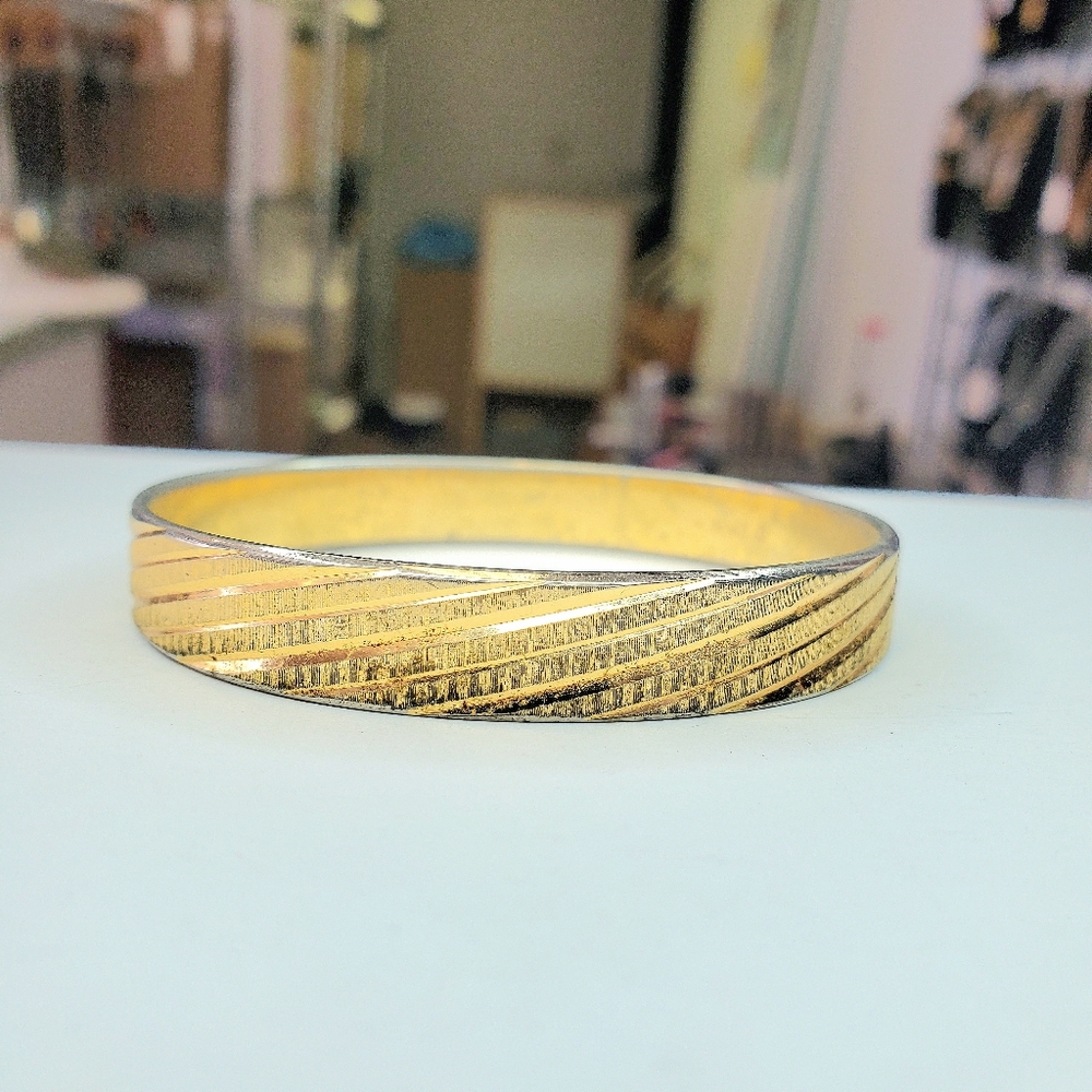 Solid metal gold colored costume bracelet